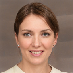 Joyful white young-adult female with medium  brown hair and grey eyes