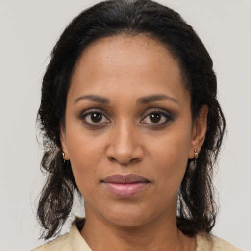 Joyful black young-adult female with medium  brown hair and brown eyes