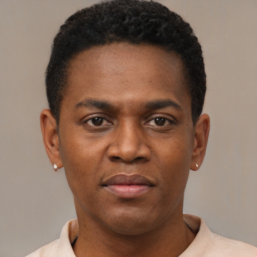 Joyful black young-adult male with short  brown hair and brown eyes