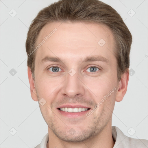 Joyful white young-adult male with short  brown hair and grey eyes