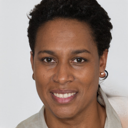 Joyful black adult female with short  black hair and brown eyes