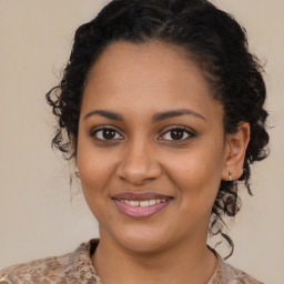 Joyful black young-adult female with medium  brown hair and brown eyes