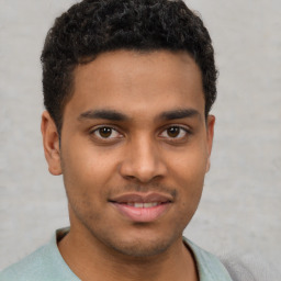 Joyful latino young-adult male with short  brown hair and brown eyes