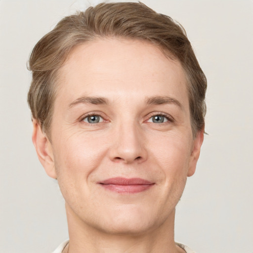 Joyful white adult female with short  brown hair and grey eyes