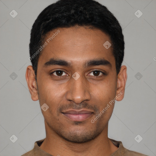 Joyful black young-adult male with short  black hair and brown eyes
