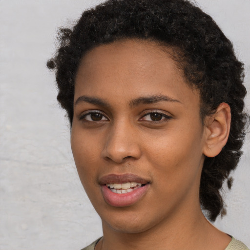 Joyful black young-adult female with short  brown hair and brown eyes