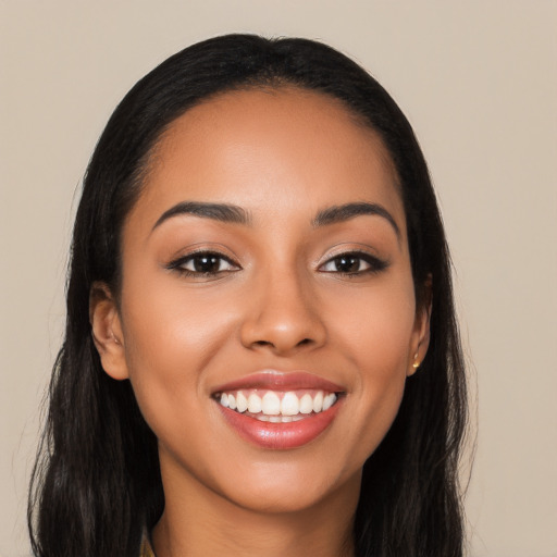 Joyful latino young-adult female with long  black hair and brown eyes