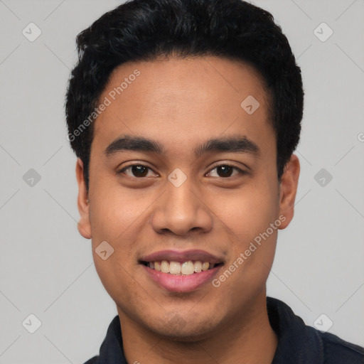 Joyful latino young-adult male with short  black hair and brown eyes