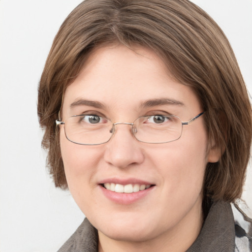 Joyful white young-adult female with medium  brown hair and grey eyes