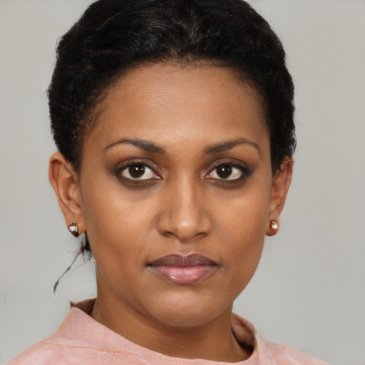 Joyful black young-adult female with short  brown hair and brown eyes