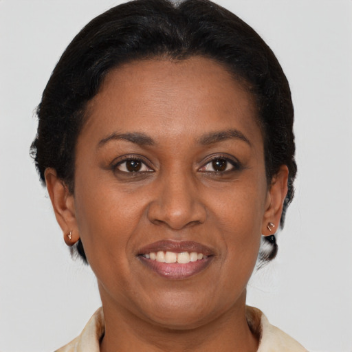 Joyful black adult female with short  brown hair and brown eyes