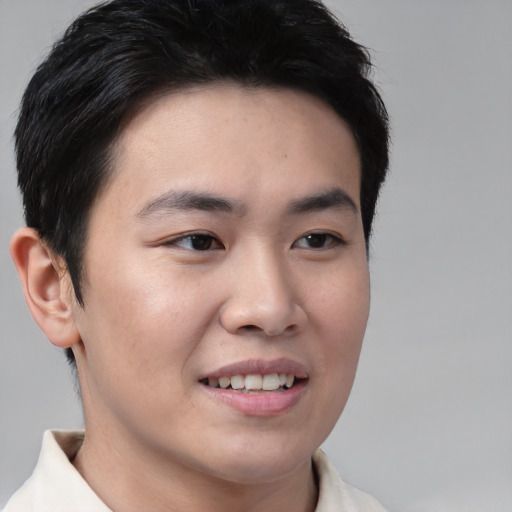Joyful asian young-adult male with short  brown hair and brown eyes
