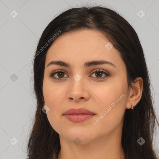 Joyful latino young-adult female with long  brown hair and brown eyes