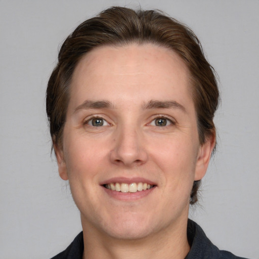 Joyful white adult male with medium  brown hair and grey eyes