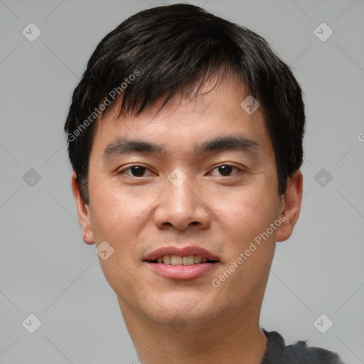 Joyful asian young-adult male with short  black hair and brown eyes