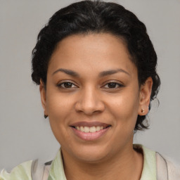 Joyful latino young-adult female with short  brown hair and brown eyes