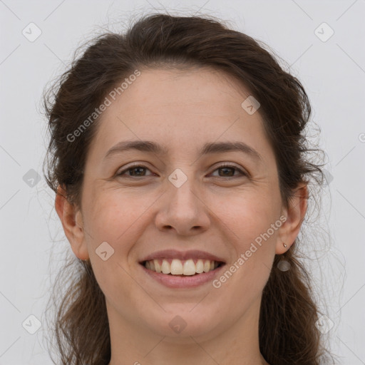 Joyful white adult female with long  brown hair and brown eyes