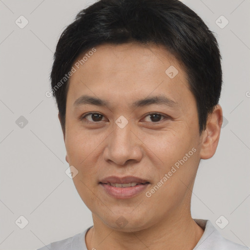 Joyful asian adult male with short  black hair and brown eyes
