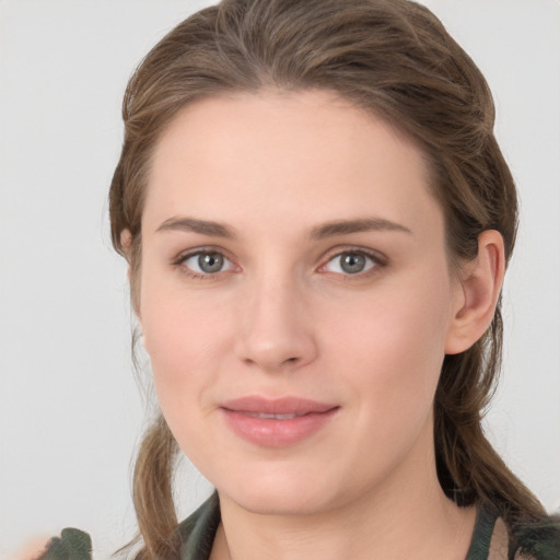 Joyful white young-adult female with medium  brown hair and grey eyes