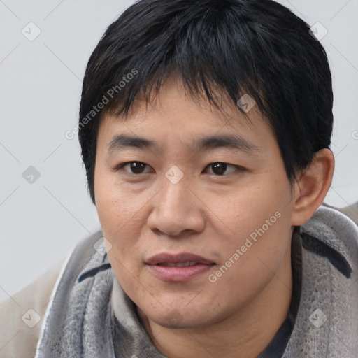 Joyful asian young-adult male with short  black hair and brown eyes