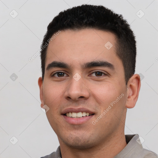 Joyful white young-adult male with short  black hair and brown eyes