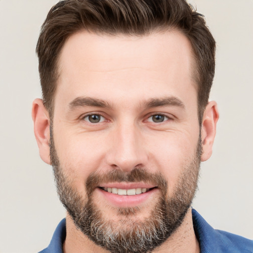 Joyful white young-adult male with short  brown hair and brown eyes