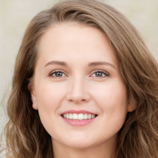 Joyful white young-adult female with long  brown hair and green eyes