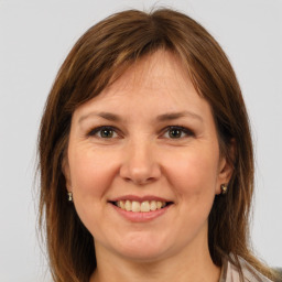 Joyful white young-adult female with medium  brown hair and grey eyes