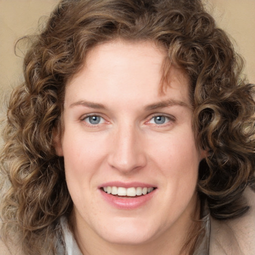 Joyful white young-adult female with medium  brown hair and green eyes