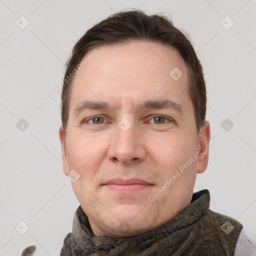 Joyful white adult male with short  brown hair and grey eyes