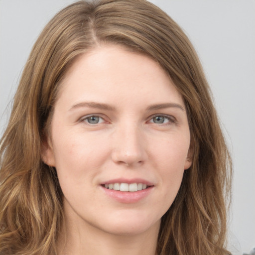 Joyful white young-adult female with long  brown hair and grey eyes