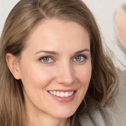 Joyful white young-adult female with long  brown hair and grey eyes