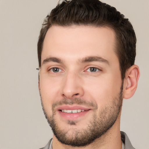 Joyful white young-adult male with short  brown hair and brown eyes