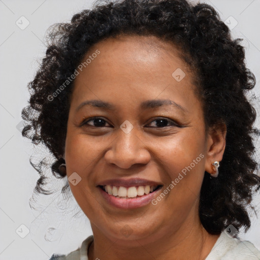 Joyful black adult female with medium  brown hair and brown eyes