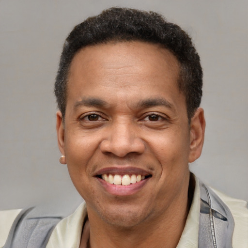 Joyful latino adult male with short  brown hair and brown eyes