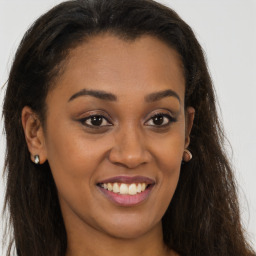 Joyful latino young-adult female with long  brown hair and brown eyes