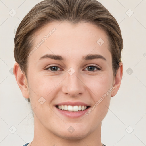 Joyful white young-adult female with short  brown hair and grey eyes