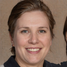 Joyful white adult female with medium  brown hair and grey eyes