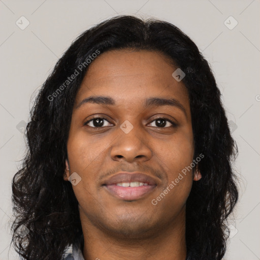 Joyful black young-adult female with long  black hair and brown eyes