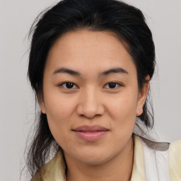 Joyful asian young-adult female with medium  brown hair and brown eyes