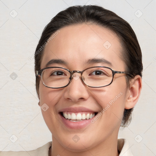 Joyful white young-adult female with medium  brown hair and brown eyes