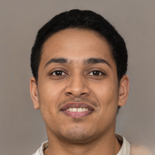 Joyful latino young-adult male with short  black hair and brown eyes