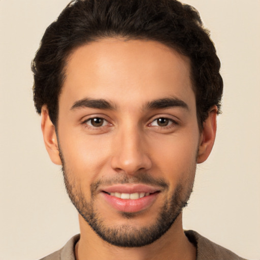 Joyful latino young-adult male with short  brown hair and brown eyes