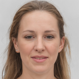 Joyful white young-adult female with long  brown hair and grey eyes