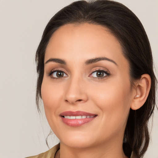 Joyful white young-adult female with long  brown hair and brown eyes