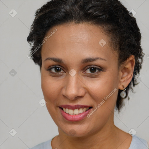 Joyful black young-adult female with short  brown hair and brown eyes