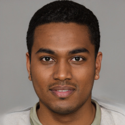 Joyful black young-adult male with short  black hair and brown eyes