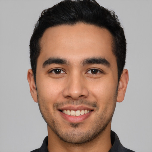 Joyful white young-adult male with short  black hair and brown eyes