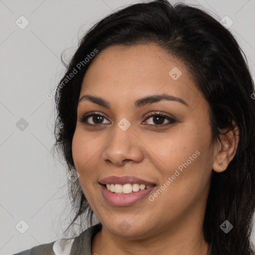 Joyful latino young-adult female with long  black hair and brown eyes