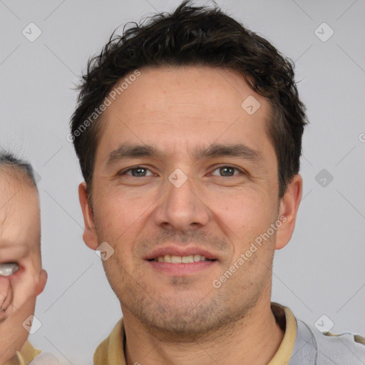 Joyful white adult male with short  brown hair and brown eyes